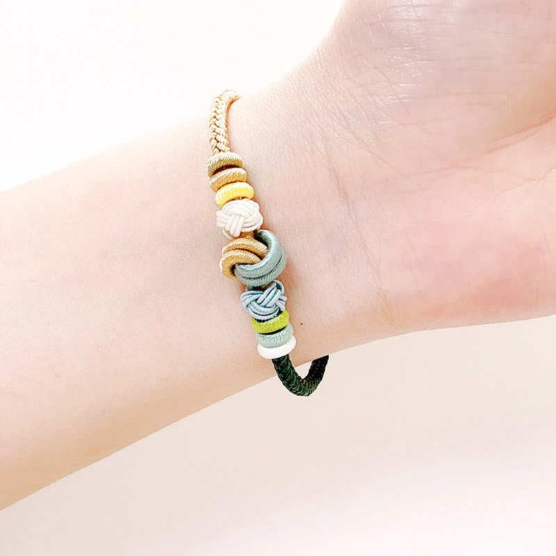 Handcrafted Two-Color Peace Knot Red String Bracelet - Image 10